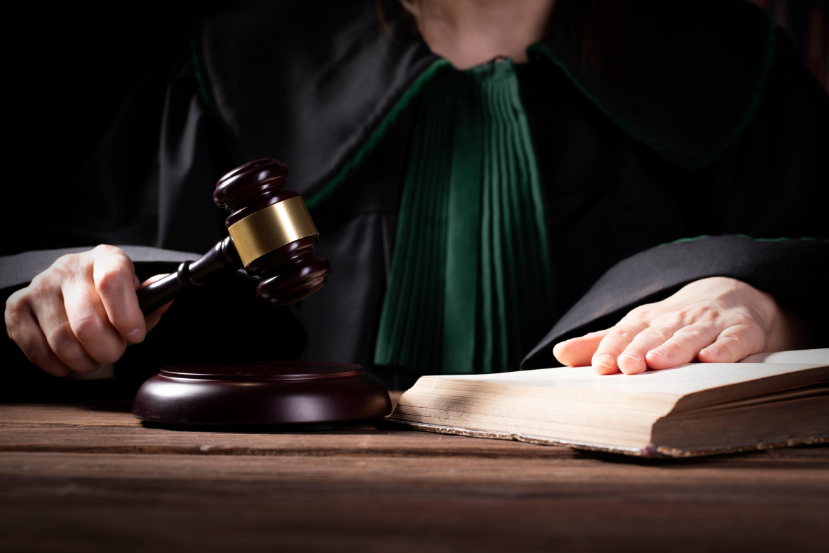 comment expulser un locataire – un juge la main sur un code de loi et un marteau de justice dans l’autre