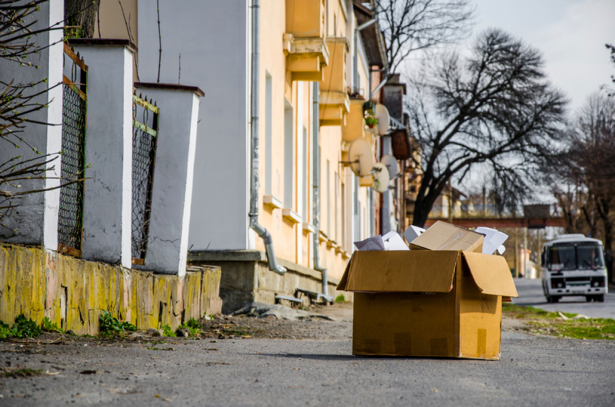 un carton d’affaires personnelles, posé devant un immeuble